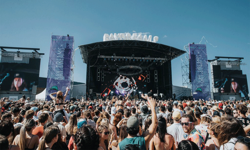 Crowd enjoying live music at Bay Dreams in front of a huge stage